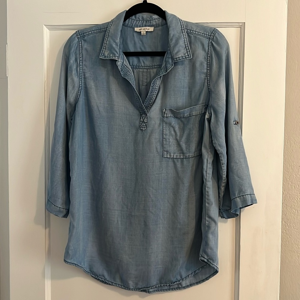 Skies are blue denim top.